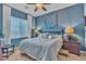 Inviting bedroom featuring neutral tones, a ceiling fan, and decorative wall art at 6227 Orto Vaso Ave, Las Vegas, NV 89131