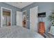 Bedroom with soothing tones and multiple doors leading to other rooms at 6227 Orto Vaso Ave, Las Vegas, NV 89131