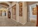 Spacious hallway featuring neutral tones, archways, tiled floors, and stylish decor at 6227 Orto Vaso Ave, Las Vegas, NV 89131