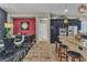 Open kitchen and dining area with granite countertops, stainless steel appliances, and decorative pendant lights at 6227 Orto Vaso Ave, Las Vegas, NV 89131