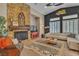 Cozy living room with a stone fireplace, plantation shutters, and comfortable seating at 6227 Orto Vaso Ave, Las Vegas, NV 89131