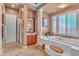 Bright bathroom with shower, bathtub, plantation shutters, and modern decor at 6227 Orto Vaso Ave, Las Vegas, NV 89131