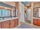 Spacious bathroom featuring double sinks, granite countertops, and a large mirror at 6227 Orto Vaso Ave, Las Vegas, NV 89131