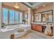 Relaxing main bathroom with garden tub, plantation shutters and vanity at 6227 Orto Vaso Ave, Las Vegas, NV 89131