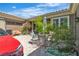 Outdoor patio area with comfortable seating, lush greenery, and partial view of a red car at 6227 Orto Vaso Ave, Las Vegas, NV 89131