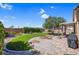 Green backyard with artificial turf, a patio, and mature landscaping offer relaxation and outdoor enjoyment at 6567 American Eagle Ave, Las Vegas, NV 89131