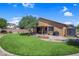 Landscaped backyard with artificial turf, a patio, and a shed offering additional storage space at 6567 American Eagle Ave, Las Vegas, NV 89131