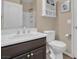 Well-lit bathroom featuring a white vanity, toilet, and storage cabinet at 6567 American Eagle Ave, Las Vegas, NV 89131