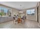 Bright dining room featuring a glass table, modern chandelier, and built-in cabinets at 6567 American Eagle Ave, Las Vegas, NV 89131