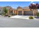 Charming single-story home with a tiled roof and a three-car garage, framed by desert landscaping at 6567 American Eagle Ave, Las Vegas, NV 89131