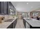 Modern kitchen with dark cabinets, stainless appliances, and large countertops at 6567 American Eagle Ave, Las Vegas, NV 89131