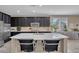 Open concept kitchen featuring a large island and dark cabinetry at 6567 American Eagle Ave, Las Vegas, NV 89131