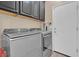 Modern laundry room featuring gray front-loading washer and dryer units at 6567 American Eagle Ave, Las Vegas, NV 89131