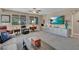 Cozy living room featuring neutral tones, large windows, plush seating, and a custom built-in media center at 6567 American Eagle Ave, Las Vegas, NV 89131