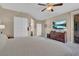 Large main bedroom with sitting area, tv, and access to the backyard patio at 6567 American Eagle Ave, Las Vegas, NV 89131