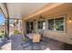 Inviting covered patio with stylish outdoor seating overlooking landscaped backyard at 6567 American Eagle Ave, Las Vegas, NV 89131
