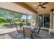 Covered patio with outdoor seating overlooking a beautifully landscaped backyard at 6567 American Eagle Ave, Las Vegas, NV 89131