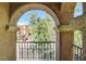 View from balcony with textured archway overlooking street with tree and red car at 6622 Colorado Spruce St, Las Vegas, NV 89149
