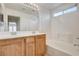 Bathroom with wooden vanity, a double sink, and a shower and tub combination at 6622 Colorado Spruce St, Las Vegas, NV 89149