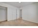 Clean bedroom with neutral carpet and view of closet with shelving and doorway with tile flooring at 6622 Colorado Spruce St, Las Vegas, NV 89149