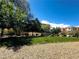 Landscaped community green area with trees near residential buildings, ideal for relaxation and recreation at 6622 Colorado Spruce St, Las Vegas, NV 89149
