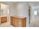 Hallway with wooden cabinets leading to the bathroom, offering storage space at 6622 Colorado Spruce St, Las Vegas, NV 89149