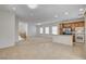 Spacious kitchen and living room with stainless appliances, tile, and breakfast bar at 6622 Colorado Spruce St, Las Vegas, NV 89149