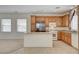 Bright kitchen featuring granite island, stainless fridge, wood cabinets, and breakfast bar at 6622 Colorado Spruce St, Las Vegas, NV 89149