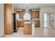 Bright kitchen featuring wood cabinets, granite countertops, and stainless steel refrigerator at 6622 Colorado Spruce St, Las Vegas, NV 89149