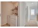 Upstairs laundry room with washer, dryer, shelving, and natural light from window at 6622 Colorado Spruce St, Las Vegas, NV 89149