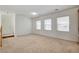 Spacious carpeted living room with ample natural light from three large windows at 6622 Colorado Spruce St, Las Vegas, NV 89149