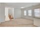 Spacious carpeted living area featuring neutral walls, recessed lighting, and staircase access at 6622 Colorado Spruce St, Las Vegas, NV 89149