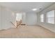 Expansive carpeted living room with neutral walls and ample lighting from recessed lights at 6622 Colorado Spruce St, Las Vegas, NV 89149