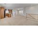 Bright, open-concept living space featuring neutral carpeting and an adjacent eat-in kitchen at 6622 Colorado Spruce St, Las Vegas, NV 89149