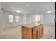 Open concept living room and kitchen area with granite island and tile floors at 6622 Colorado Spruce St, Las Vegas, NV 89149
