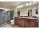 Lovely bathroom featuring a granite-topped vanity, double sinks, and a large tiled shower at 6726 Glissando Ct, Las Vegas, NV 89139
