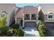 Two-story home with a large garage, balcony, and desert landscaping at 6726 Glissando Ct, Las Vegas, NV 89139