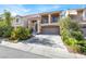 Two-story home with a two-car garage, a balcony, and desert landscaping at 6726 Glissando Ct, Las Vegas, NV 89139