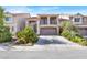 Two-story home featuring a front-facing two car garage, balcony, and well maintained landscaping at 6726 Glissando Ct, Las Vegas, NV 89139