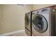 Well-equipped laundry room with modern, front loading, stainless steel washer and dryer at 6726 Glissando Ct, Las Vegas, NV 89139