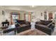 Cozy living room with comfortable seating and natural light from the windows and nearby kitchen at 6726 Glissando Ct, Las Vegas, NV 89139
