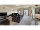 Spacious living room featuring plush seating, neutral tones, and access to the outdoor balcony at 6726 Glissando Ct, Las Vegas, NV 89139
