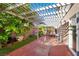 Inviting covered patio features lush greenery, plants and ample space for outdoor enjoyment at 6726 Glissando Ct, Las Vegas, NV 89139