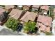 Overhead view of the property nestled among neighboring houses, landscaped with mature trees at 7042 Grand Junction Ave, Las Vegas, NV 89179