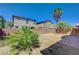 View of the backyard showing a retaining wall and minimal desert landscaping at 7042 Grand Junction Ave, Las Vegas, NV 89179