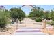 Community park path that invites residents to take a stroll amidst the trees and landscaped scenery at 7042 Grand Junction Ave, Las Vegas, NV 89179