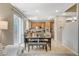 Bright open-concept living space features a dining area with kitchen views and sliding door access at 7042 Grand Junction Ave, Las Vegas, NV 89179