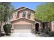 Charming two-story home featuring a two-car garage and well-maintained front yard at 7042 Grand Junction Ave, Las Vegas, NV 89179
