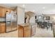 Well-equipped kitchen with stainless steel refrigerator, granite counters, and dining area access at 7042 Grand Junction Ave, Las Vegas, NV 89179