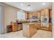Well-lit kitchen boasts stainless steel appliances, granite countertops, and ample cabinet space at 7042 Grand Junction Ave, Las Vegas, NV 89179